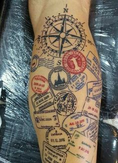 a person with a compass tattoo on their leg and some stamps around the foot that are all over them