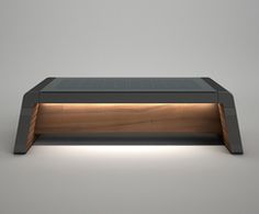 an illuminated coffee table in the middle of a room with grey walls and flooring