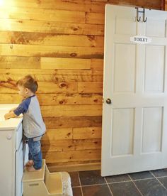 a little boy standing on top of a step stool