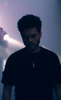 a man standing in front of a wall with a light on it's side