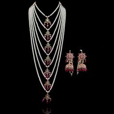 Radiating the elegance of our culture, this heritage piece speaks of sophistication and excellence! Exuding old-world charm, this set is strung together with beautiful stones and complementing pearl moti. Approximate mala length is 19". The set includes a pair of matching earrings. Approximate earrings length is 3". Gold-plated on high-quality brass as the base metal. Mahira Set (Emerald) is in-stock & ready-to-ship. Delivery time frame for the Mahira Set (Ruby) & Mahira Set (Sapphire) is 4-6 we Traditional Chandbali Pearl Necklace With Tilla, Traditional Chandbali Jewelry Sets With Pearl Chain, Traditional Pearl Chandbali Necklace, Diwali Temple Jewelry Sets With Pearl Chain, Traditional Tilla Chandbali Pearl Necklace, Traditional Pearl Jewelry With Cutdana, Traditional Hand Set Pearl Necklace For Festivals, Traditional Hand-set Pearl Necklace For Festivals, Bollywood Bridal Necklace With Intricate Pearl Design