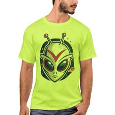 a man wearing a neon green alien t - shirt with an alien head on it