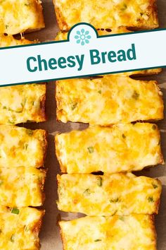 cheesy bread cut into squares sitting on top of a table with a sign above it