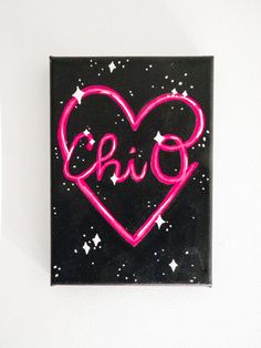 a black and pink heart with the word chio painted on it's side