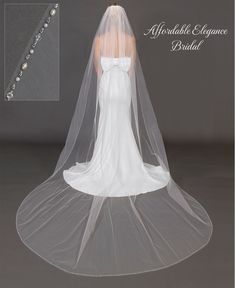 a bridal veil with beaded trim and pearls on the bottom is shown in white