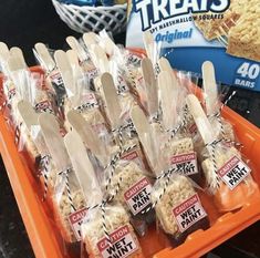 there are many bags of rice krispy kreme treats in the trays