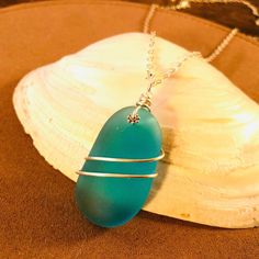 This beautiful sea glass pendant necklace is made from a large 1.5-inch piece of smooth, turquoise blue sea glass wrapped with tarnish-resistant, silver-plated wire. Our standard 20" necklace cords are made of weaved faux leather (your choice of black/brown/white) with a lobster clasp closure. Our bright silver chains are made of solid .925 sterling silver, are elegant yet durable, and are imported from Italy.  ❤️❤️We welcome you to visit our Necklace Section for more handcrafted sea glass jewelry designs: https://www.etsy.com/shop/pendantsforacause/?section_id=27339636 ---------- LOOKING FOR SOMETHING ELSE? ---------- 🔷 Come browse my other sea glass jewelry designs! Feel free to request a custom order as well. 🔴 PendantsForACause.etsy.com 🔴 ---------- PACKAGING ----------  🎁 Each han Turquoise Wire Wrapped Sea Glass Jewelry, Turquoise Sea Glass Wire Wrapped Jewelry, Turquoise Sea Glass Necklace For Beach, Turquoise Wire Wrapped Necklace For Beach, Turquoise Glass Wire Wrapped Necklace, Turquoise Wire Wrapped Glass Necklace, Turquoise Wire Wrapped Glass Necklaces, Wire Wrapped Turquoise, Beach Glass Jewelry