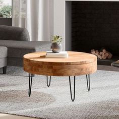 a coffee table with hairpin legs sits in front of a fire place and couch