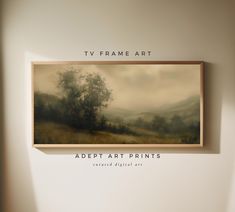 a tv frame hanging on the wall above a painting