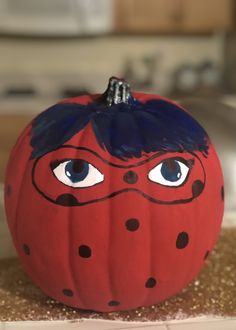 a painted pumpkin sitting on top of a counter