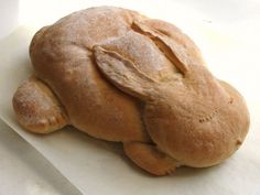 a white plate topped with a loaf of bread