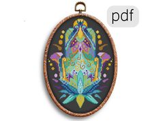 a cross stitch pattern with the letter df in it's center and an oval frame