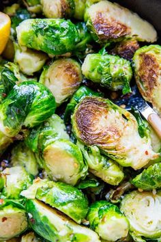 brussel sprouts with lemon wedges in a skillet