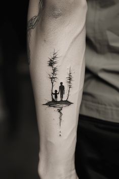 a man and woman are standing in front of a lake with trees tattoo on their legs