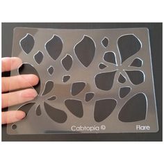 a person holding onto a clear plastic tray with black and white designs on it,