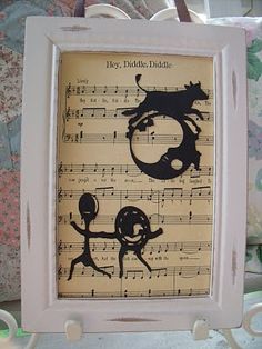 an old sheet music frame with two silhouettes on it