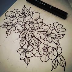 a drawing of flowers on a table with a marker next to it and a pen