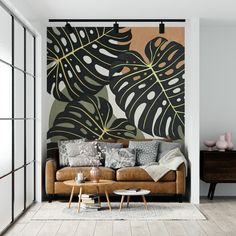 a living room with a couch, coffee table and wall mural