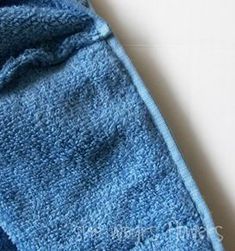 a close up of a blue towel on a white surface