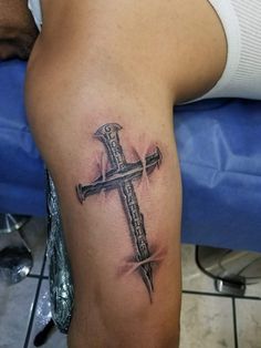 a man with a cross tattoo on his leg