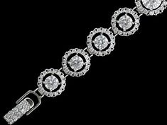 CZ Wedding Bracelet b4542 This glistening bridal bracelet features a rhodium silver plated design with graduating sizes of sparkling CZ crystals. Designed for smaller wrists, this bracelet will be add lots of bling to your wedding ensemble, Size: Decorated portion is 6" long and 0.5" wide at widest point. Color: Silver/Clear. Style: b4542. Please allow 1 week for delivery. Shipping Policy . Return Policy. White Gold Round Crystal Bracelet For Wedding, Wedding Sterling Silver Bracelet With Diamond Accents, Elegant Wedding Bracelets With Halo Design, Brilliant Cut Sterling Silver Bracelet For Weddings, Bridal Bracelet, Plate Design, Wedding Bracelet, Return Policy, Silver Plated