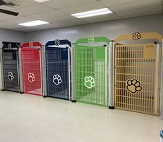 a row of dog kennels with their doors open in an empty office space