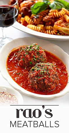 two white plates filled with meatballs covered in marinara sauce