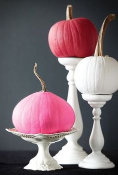 three white and pink pumpkins sitting on top of each other