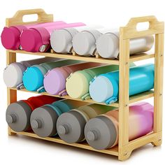 a wooden rack filled with lots of different colored cups and lids on top of each other