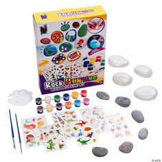 an assortment of arts and crafts materials in a box with rocks, watercolors, and markers