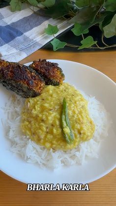 a white plate topped with rice and meat