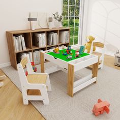 a child's play table and chairs in a room with bookshelves, windows, and toys