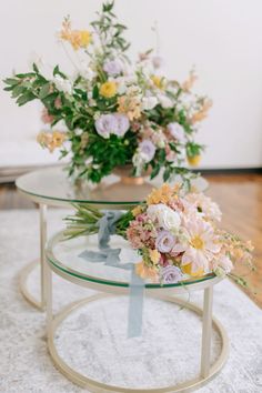 two glass tables with flowers on them