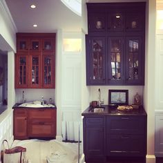 a kitchen that is being remodeled with dark wood cabinets and white walls, along with an island in the middle