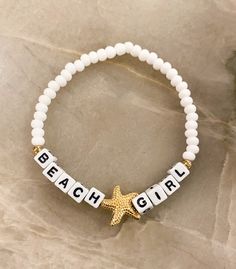 "Beach ⭐️Girl Bracelet  Sand. Salt. Sea. The perfect bracelet for the Beach Girl 🐚 Made with white 6mm seed beads, gold accents, gold starfish bead and 4mm (smaller) square letters that read \"BEACH GIRL\" If you would like another word or color, please put in Personalization Section* and we will message you if we have any questions.  CARING TIPS FOR YOUR JEWELRY ⭐️Treat and store with care. ⭐️ For longevity, avoid exposing your jewelry to water. ⭐️ Avoid having direct contact with lotions, perfumes, sanitizers as these chemicals may cause discoloration of your jewelry." Personalized Gold Friendship Bracelets For Beach, Beaded Bracelets Beach, Handmade White Starfish Bracelets, Cute Beach Jewelry With Letter Beads, Adjustable Star Bracelets For The Beach, White Star-shaped Adjustable Beaded Bracelets, Adjustable White Star-shaped Beaded Bracelets, Bracelet Sayings Words, White Letter Beads Friendship Bracelets For Beach Season