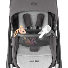 the baby stroller has an infant's bottle and spoon in its pocket,