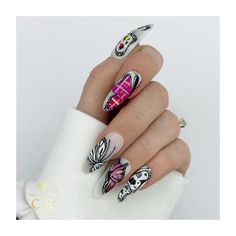 a woman's hand with colorful nail art on it