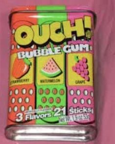 a can of bubble gum sitting on top of a pink surface with the words ouch in it