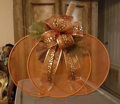 an orange plate with a brown bow on it