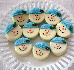 frosted snowman cookies are arranged on a plate