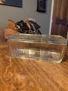 a glass container sitting on top of a wooden table