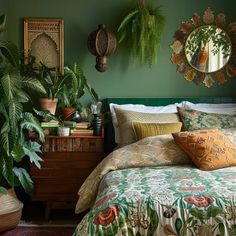 a bedroom with green walls and lots of plants