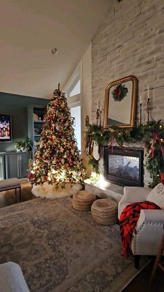 a living room with a christmas tree in the corner and other decorations on the wall