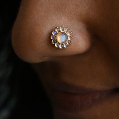 "Enchanting rainbow Moonstone floral stud, crafted in solid 14k 18k gold in a mesmerizing bezel and prong mixed setting. The cabochon cut of the natural moonstones with a subtle blue sheen render calmness, like fragrant flowers of heaven. This stud makes a bold piece for your nostril piercing, a unique pick for your philtrum and a comfortable everyday pair for your ears. Versatile and stunning. It is available as single and pair with different backing styles to suit various piercings. Please refer last image.  *  Gold: 14k/18k Solid Gold  *  Gold Colour: Yellow / Rose / White  *  Gold Wt.: ~0.80 gm (14kt) *  Gemstone: Natural Rainbow Moonstone *  Moonstone Size: ~4 mm (Centre) + 1.5mm (Halo) *  Moonstone Cut: Round Cabochon  *  Moonstone Wt.: ~0.60 Ct *  Please refer last image for backing Gold Multi-stone Moonstone Jewelry, Gold Cabochon Gemstones For Wedding, Unique Yellow Gold Moonstone Jewelry, Yellow Gold Moonstone Jewelry, Yellow Gold Multi-stone Moonstone Jewelry, Celestial Multi-stone Gold Jewelry, Celestial Multi-stone Yellow Gold Jewelry, Celestial Yellow Gold Multi-stone Jewelry, Multi-stone Moonstone Gemstones For Gift