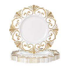 a white and gold plate sitting on top of each other