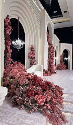 the room is decorated with pink flowers and chandeliers