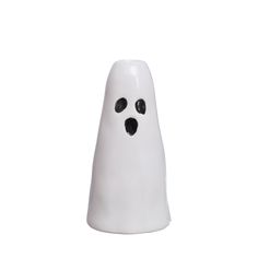 a white ceramic ghost with black eyes