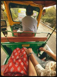 two people sitting in the back of a truck