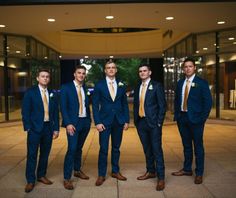 a group of men in suits standing next to each other