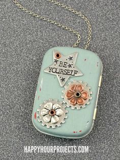 a necklace with gears on it that says bee yourself and is attached to a chain